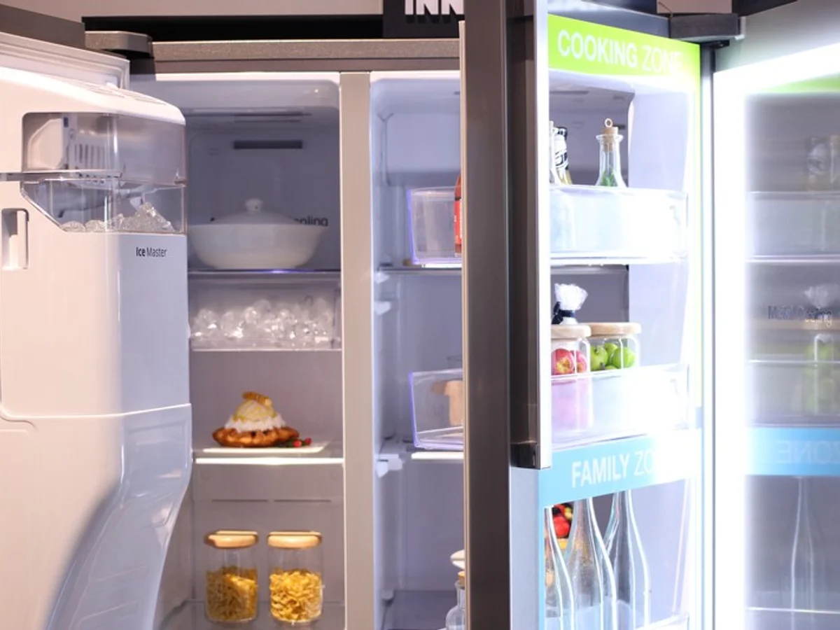 Technician inspecting a refrigerator
